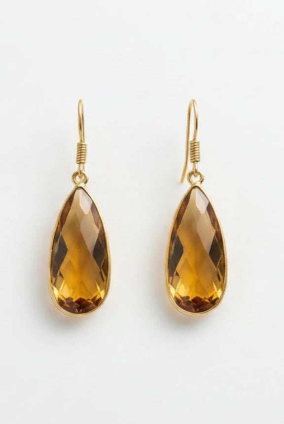 Emilia Merz Aurea drop earrings featuring golden amber teardrop-shaped faceted stones set in 18K gold plating.