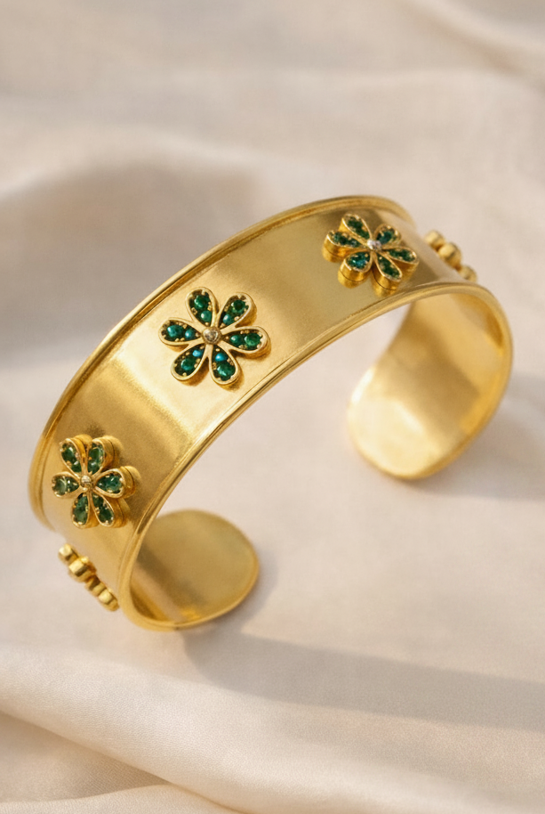 Close-up of the Emerald Bloom Cuff, highlighting the intricate floral motif and high-shine golden finish.