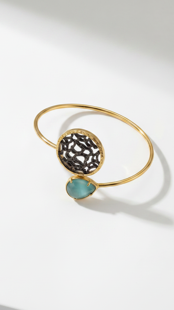 Golden bracelet with blue gemstone on light background from emilia merz
