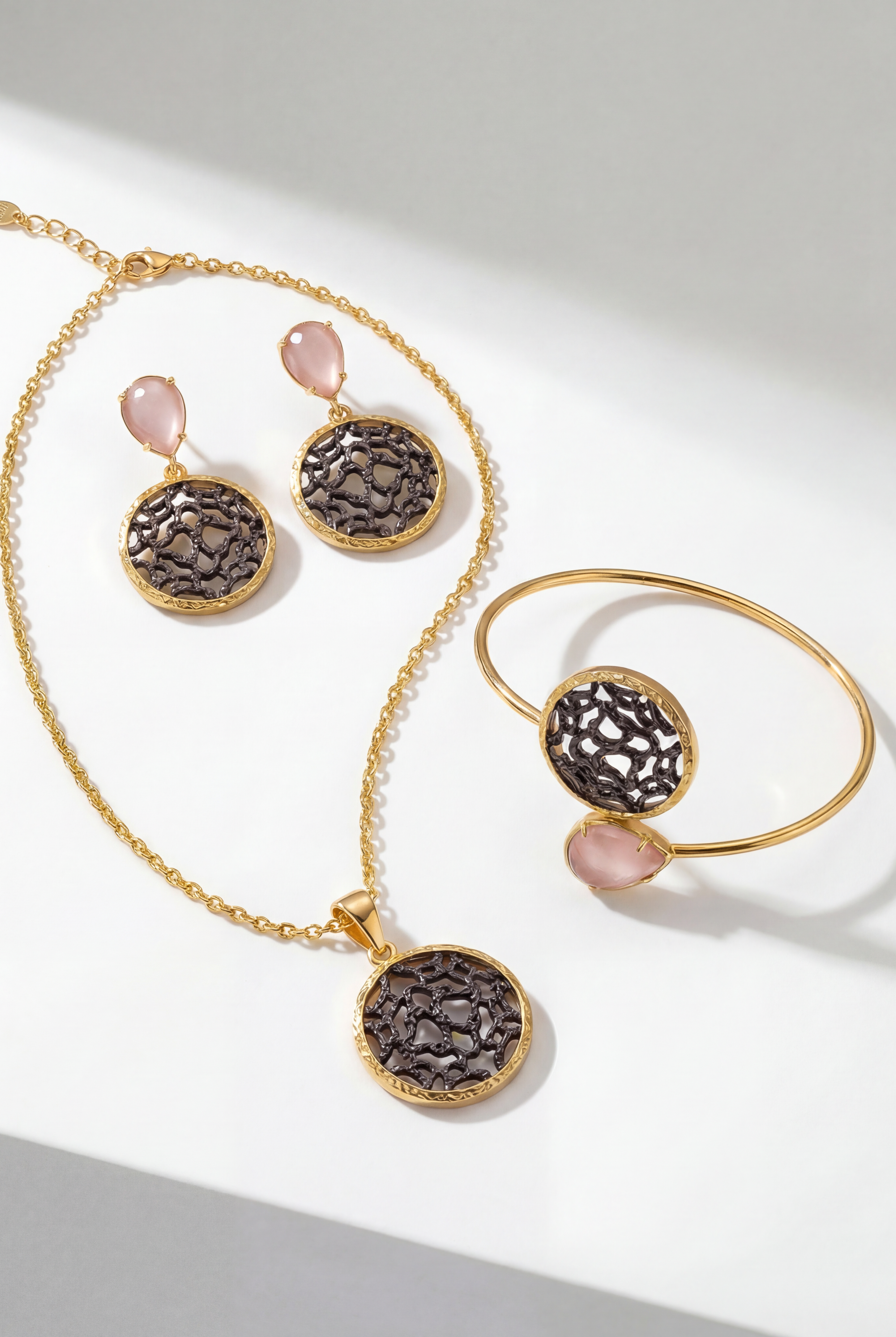 The Lumina Drop Cuff in Peach styled alongside matching filigree medallion jewelry.