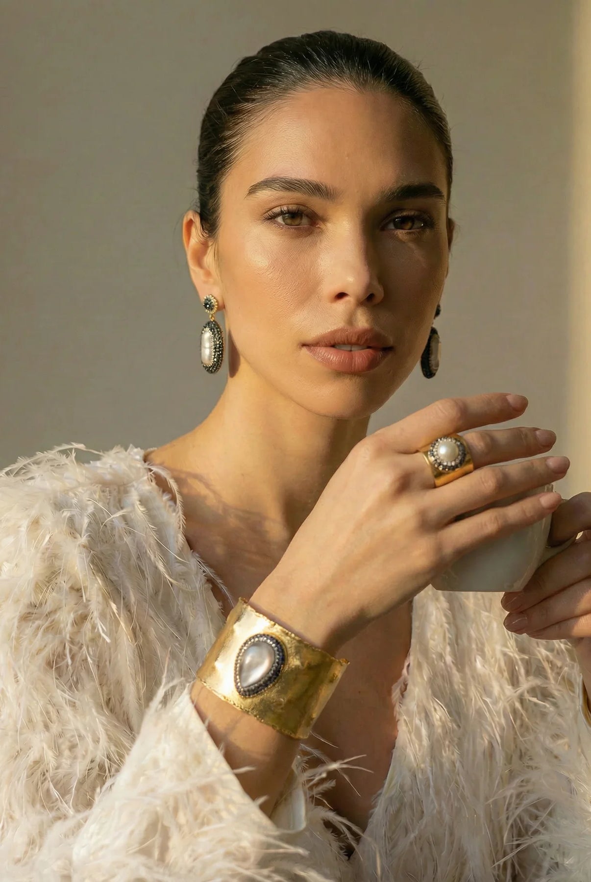 The Midnight Pearl Ring displayed with the matching Pearl Aura Cuff and statement earrings.