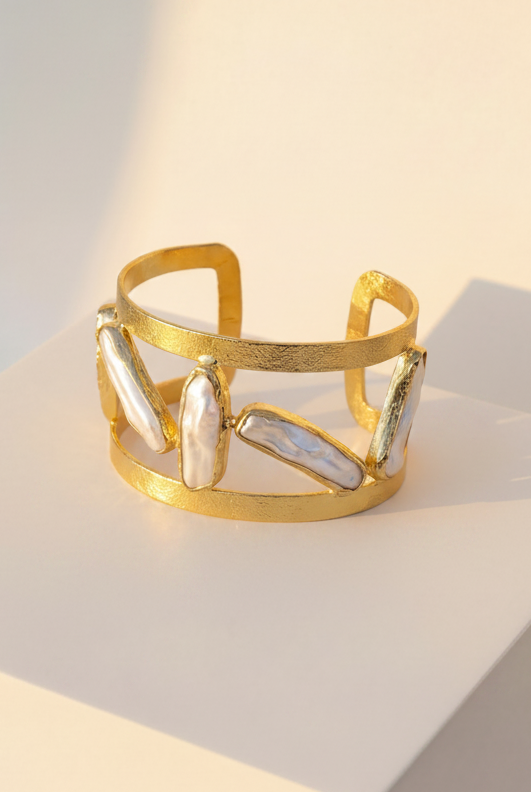 Emilia Merz Oceana Pearl Cuff featuring a wide 18K gold-plated cuff with organic freshwater pearls.