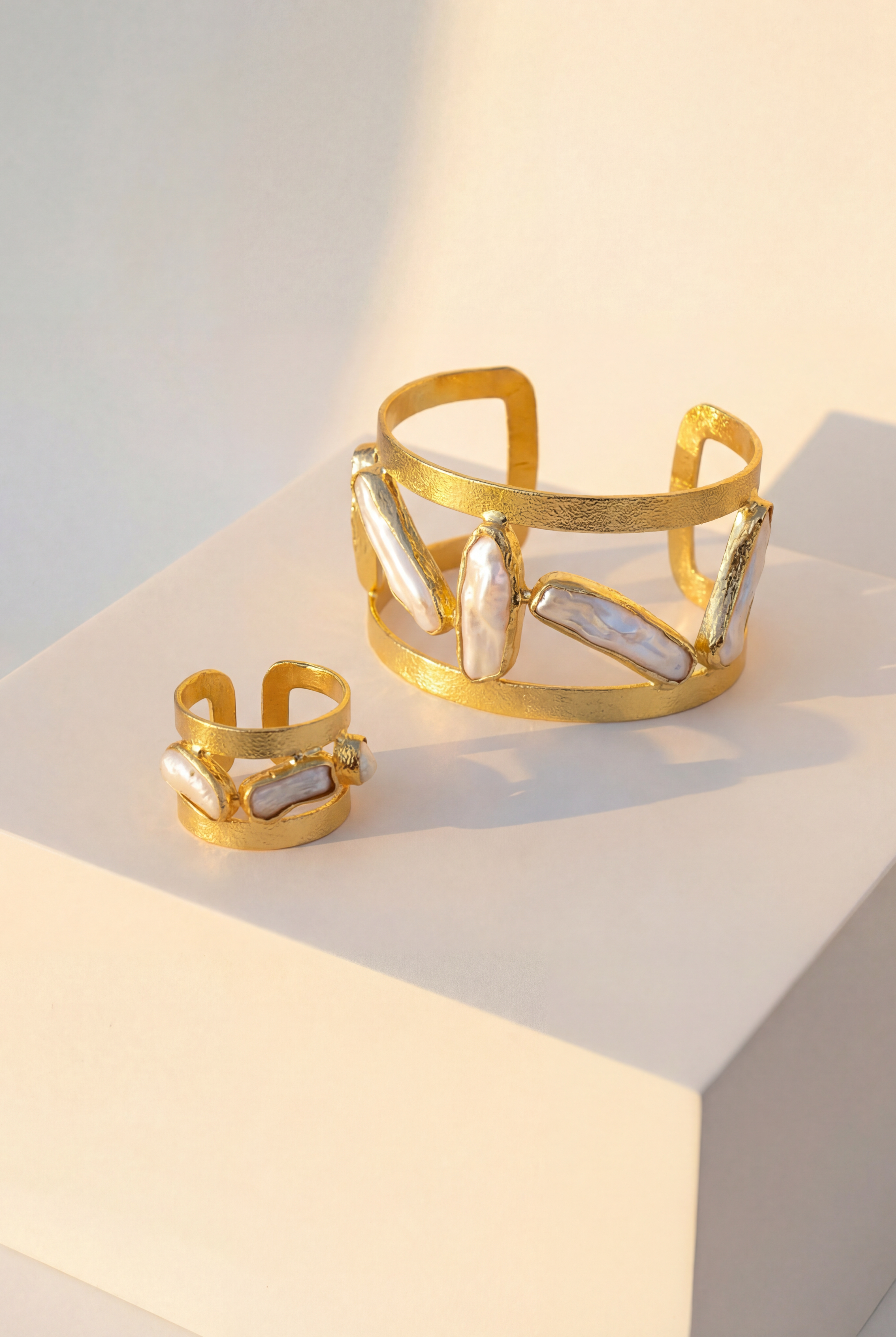 Close-up of the Oceana Pearl Ring and Cuff, highlighting the organic pearl shapes and textured gold finish.