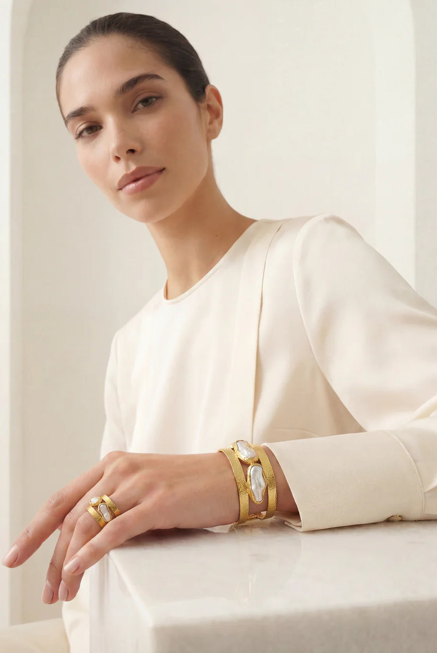 The Oceana Pearl Ring on a neutral background, showcasing its delicate multi-band design and unique pearl accents.