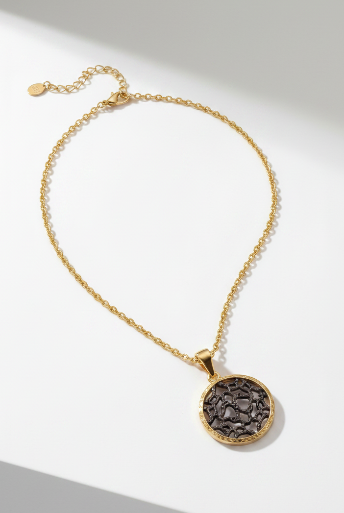 Emilia Merz Lumina Medallion Necklace featuring an intricate gold filigree pendant on a delicate chain.
