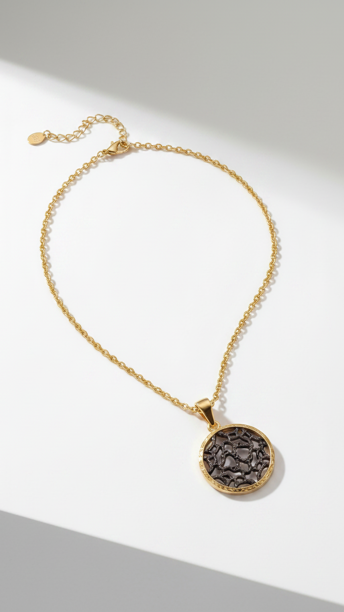 Emilia Merz Lumina Medallion Necklace featuring an intricate gold filigree pendant on a delicate chain.