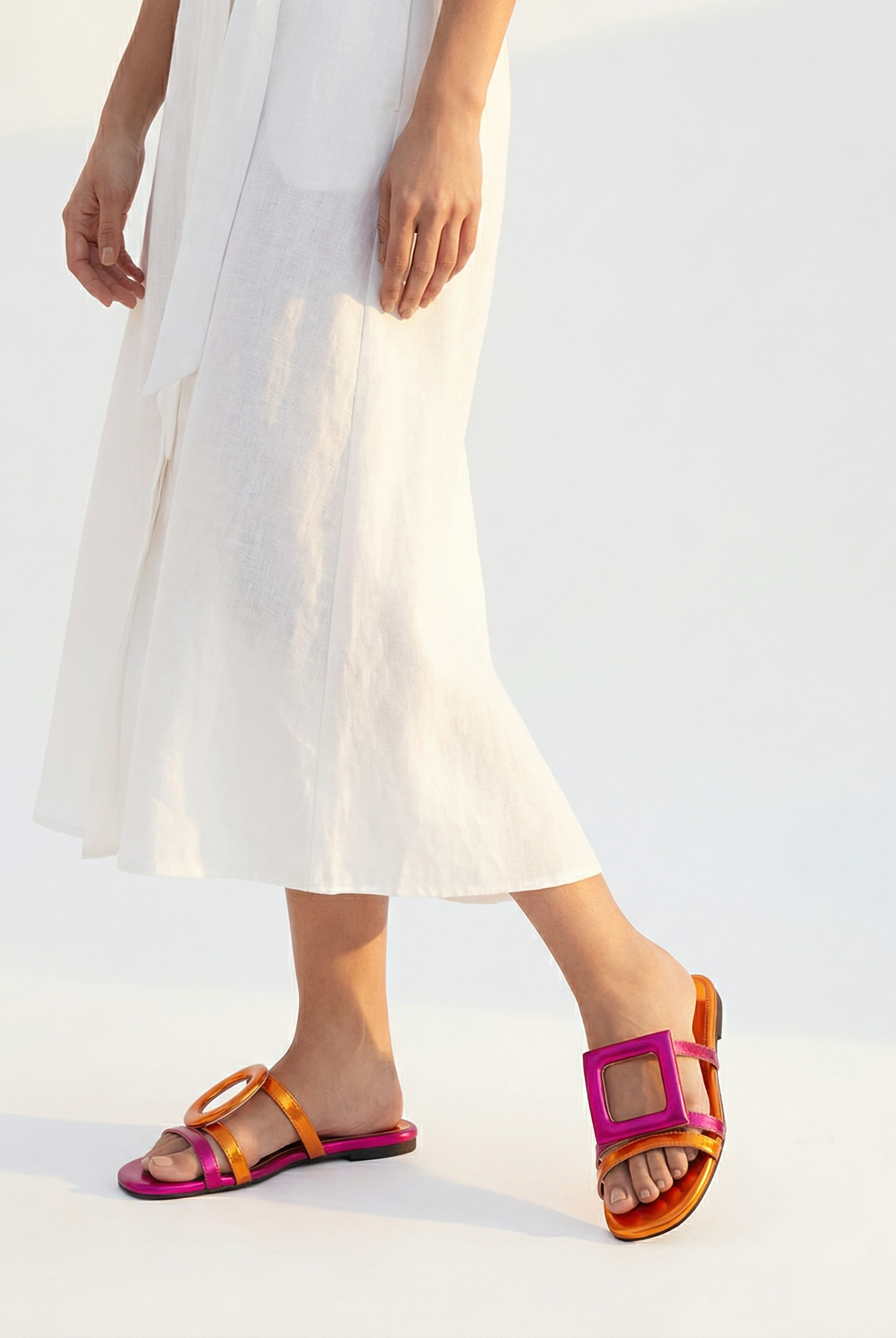 Person wearing colorful sandals with a white background