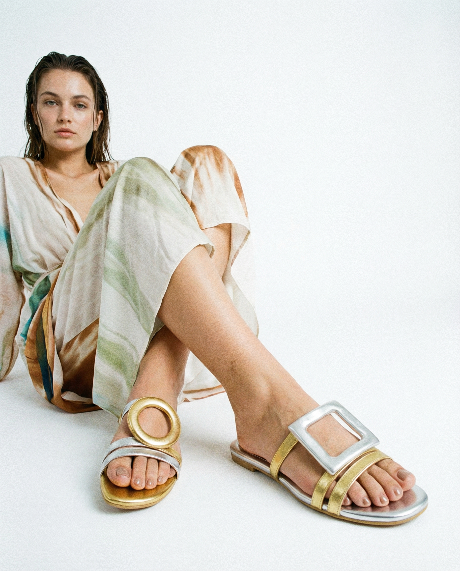 Woman wearing summer sandals with a plain background