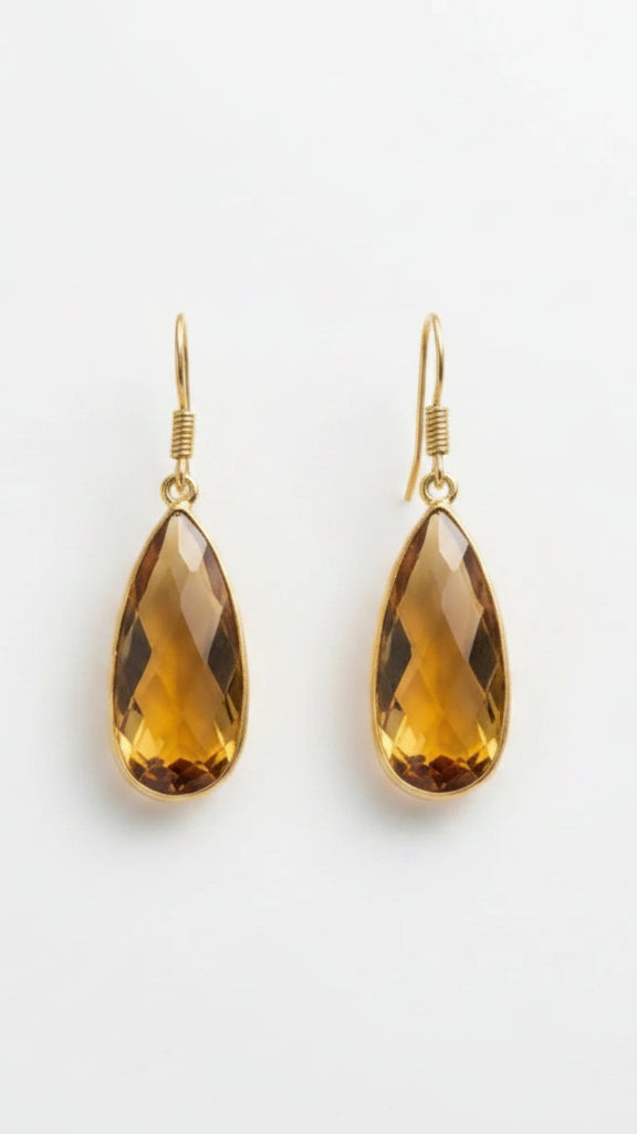 Emilia Merz Aurea drop earrings featuring golden amber teardrop-shaped faceted stones set in 18K gold plating.