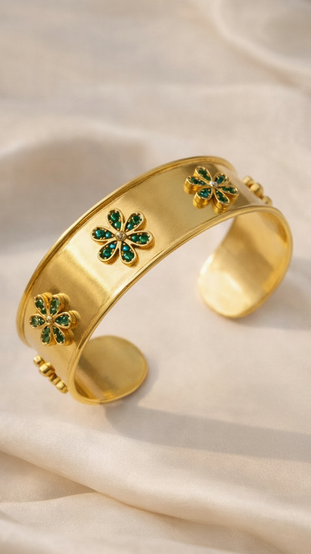 Close-up of the Emerald Bloom Cuff, highlighting the intricate floral motif and high-shine golden finish.