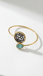 Golden bracelet with blue gemstone on light background from emilia merz