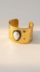 Emilia Merz Pearl Aura Cuff featuring an 18K gold-plated brass finish with a central freshwater pearl and crystal halo.