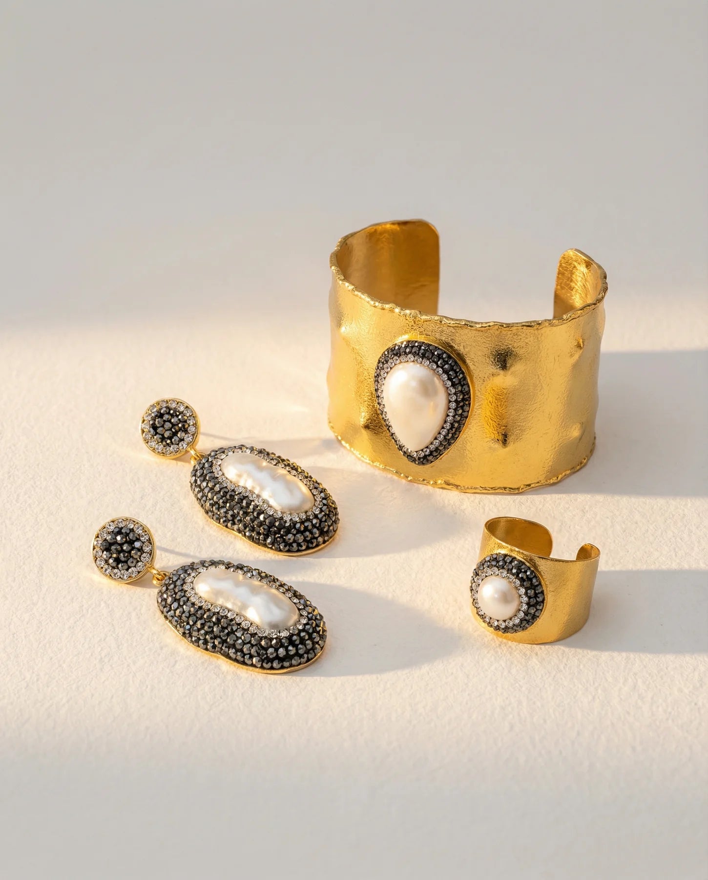 Close-up of the Pearl Aura Cuff alongside the matching earrings and ring.