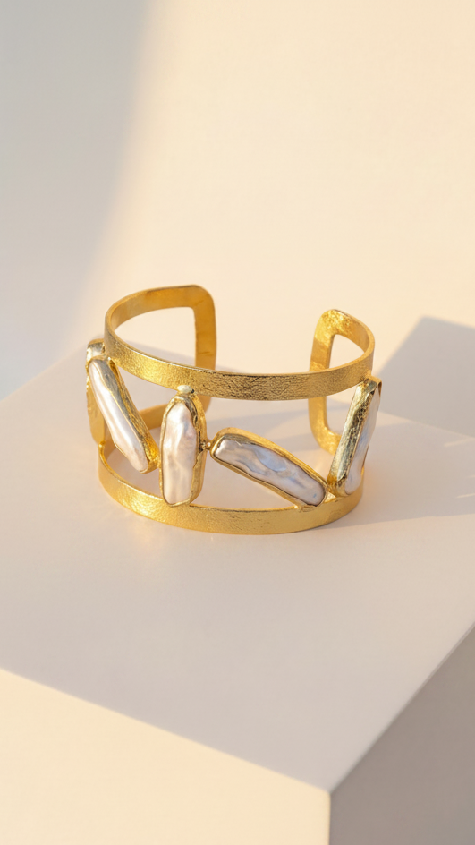 Emilia Merz Oceana Pearl Cuff featuring a wide 18K gold-plated cuff with organic freshwater pearls.