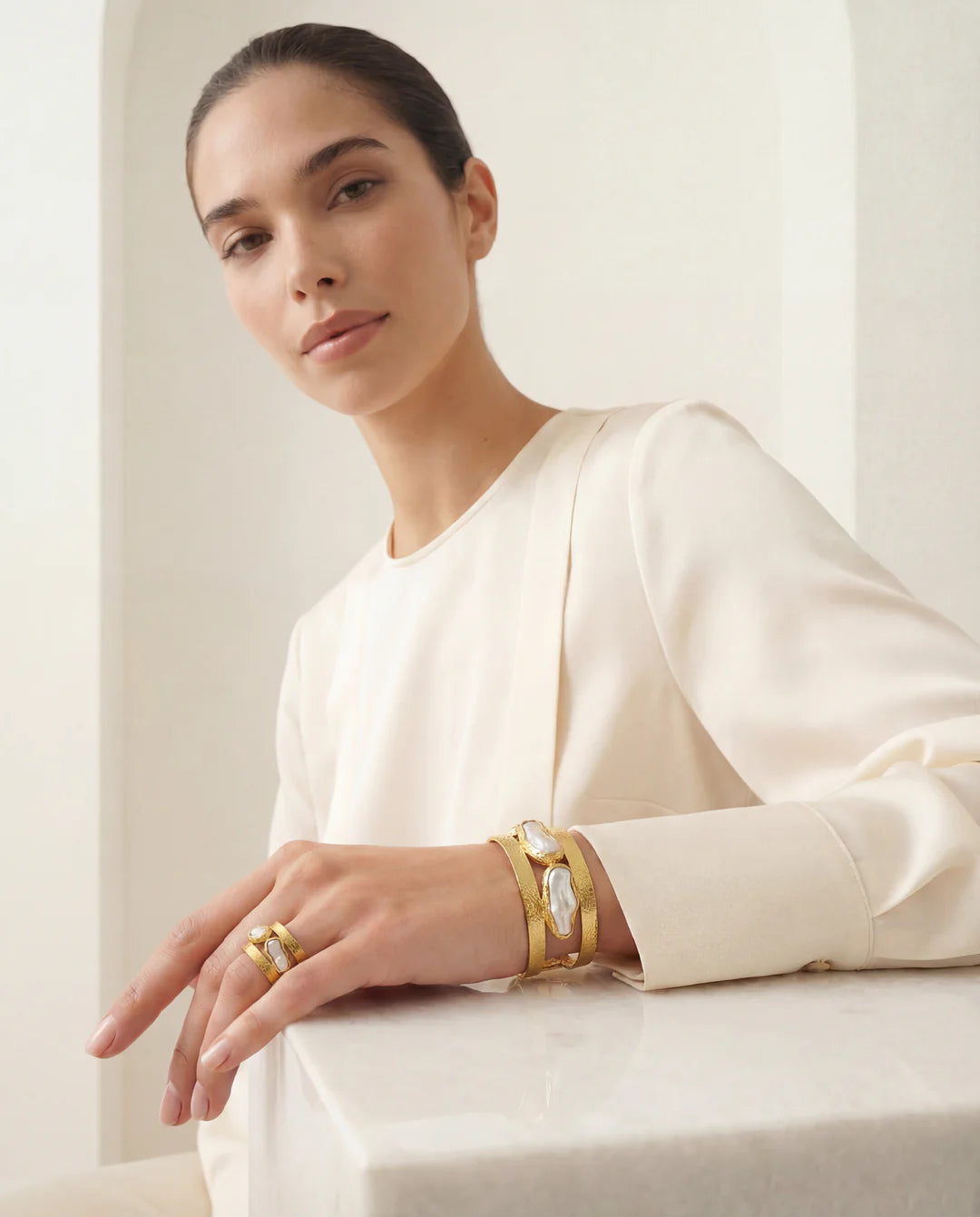 The Oceana Pearl Ring on a neutral background, showcasing its delicate multi-band design and unique pearl accents.