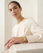 The Oceana Pearl Ring on a neutral background, showcasing its delicate multi-band design and unique pearl accents.