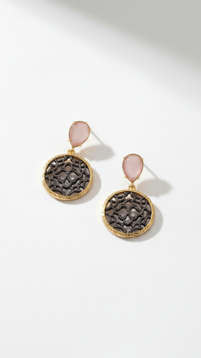 Emilia Merz Lumina Drop Earrings featuring rose-colored teardrop crystals and gold filigree discs.