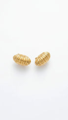 Marbella Shell Earrings featuring large, ribbed 18K gold-plated shell Emilia Merz 