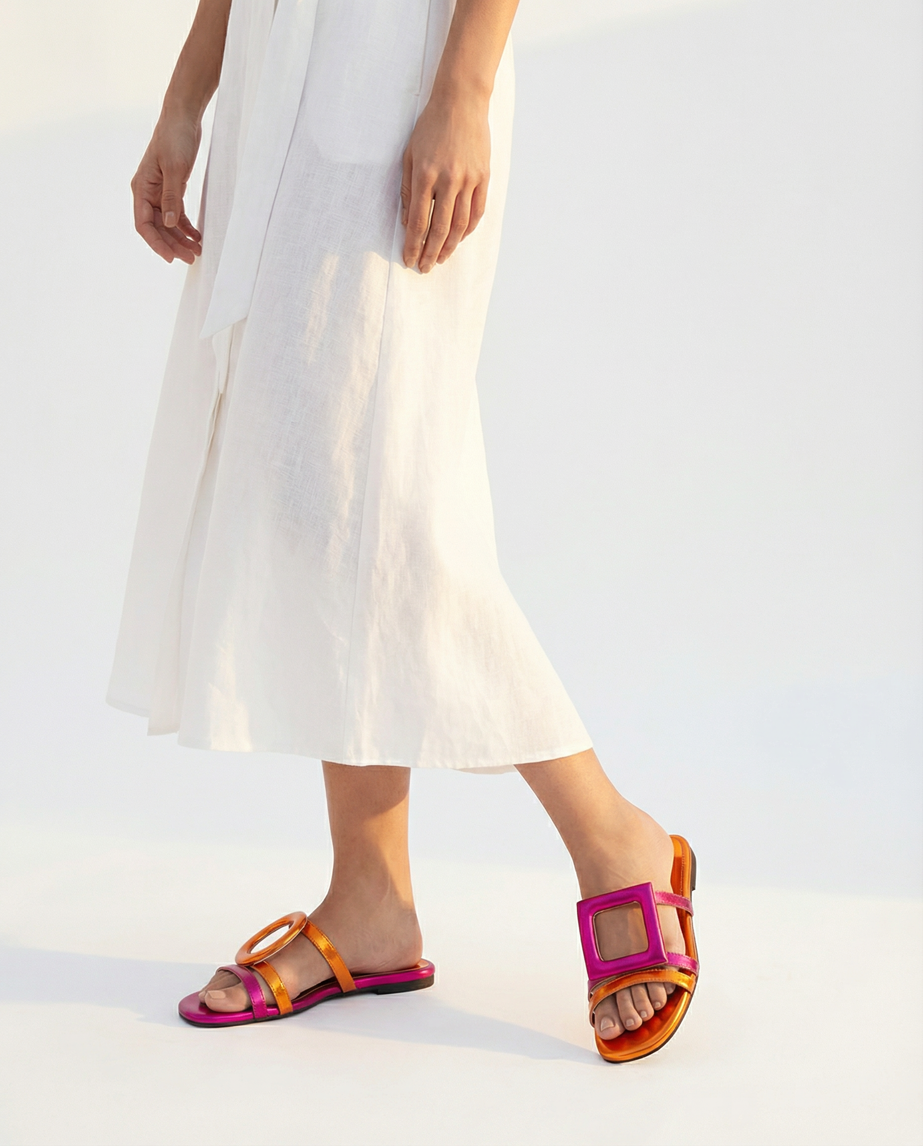Person wearing colorful sandals with a white background