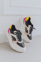 Pair of stylish sneakers with colorful accents on a light background