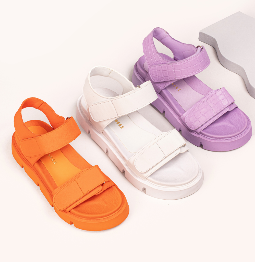 three different colored chunky platform sandals in orange white and purple from emilia merz